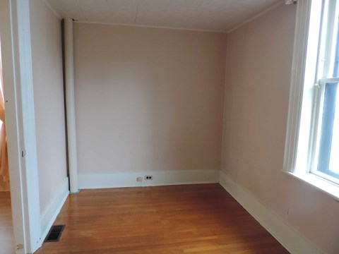 A room with wooden floors and white walls.
