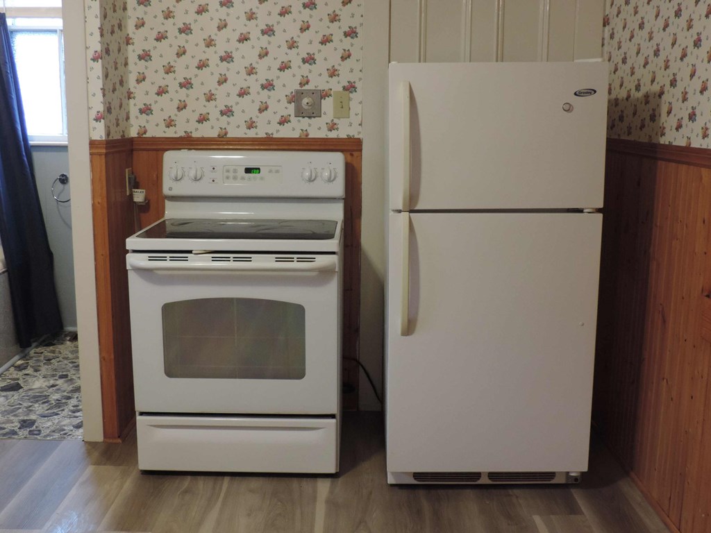 a white stove and refrigerator in a kitchen
