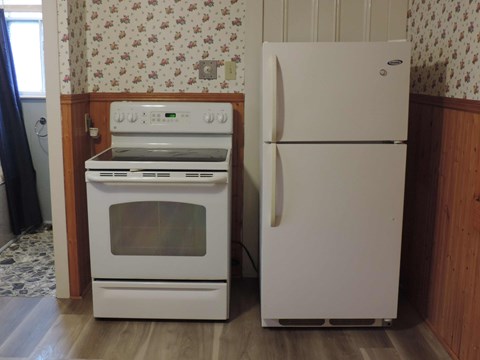 a white stove and refrigerator in a kitchen