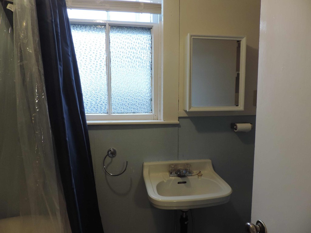 a small bathroom with a sink and a window