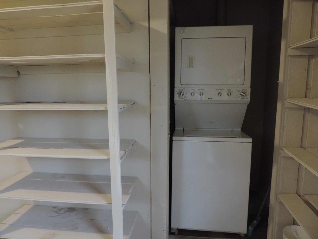 a refrigerator and a washing machine in a closet