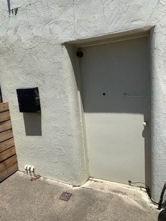 A white door is closed with a small window above it.