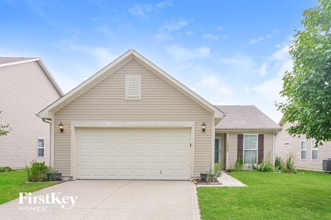 a beige house with a white garage door