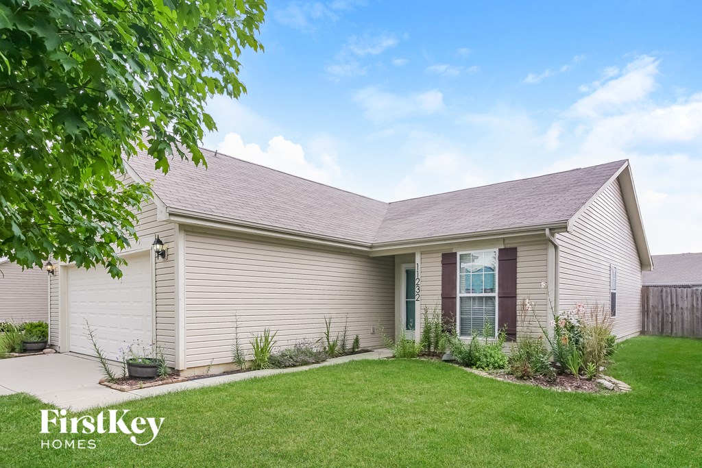 a white house with a lawn in front of it