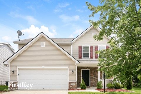 a tan house with a white garage door