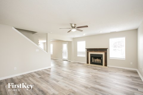 the living room has a fireplace and hardwood floors