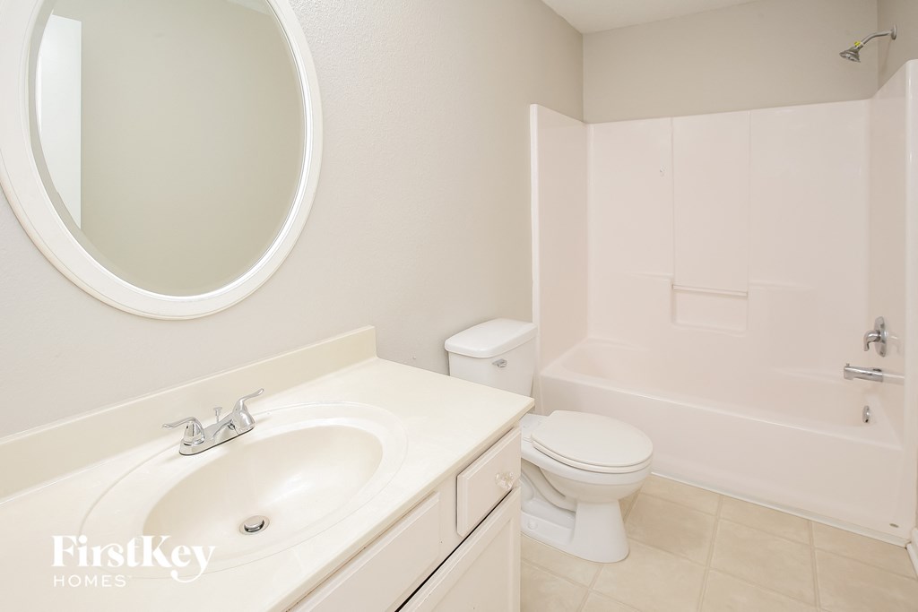 a bathroom with a sink and a toilet and a bath tub