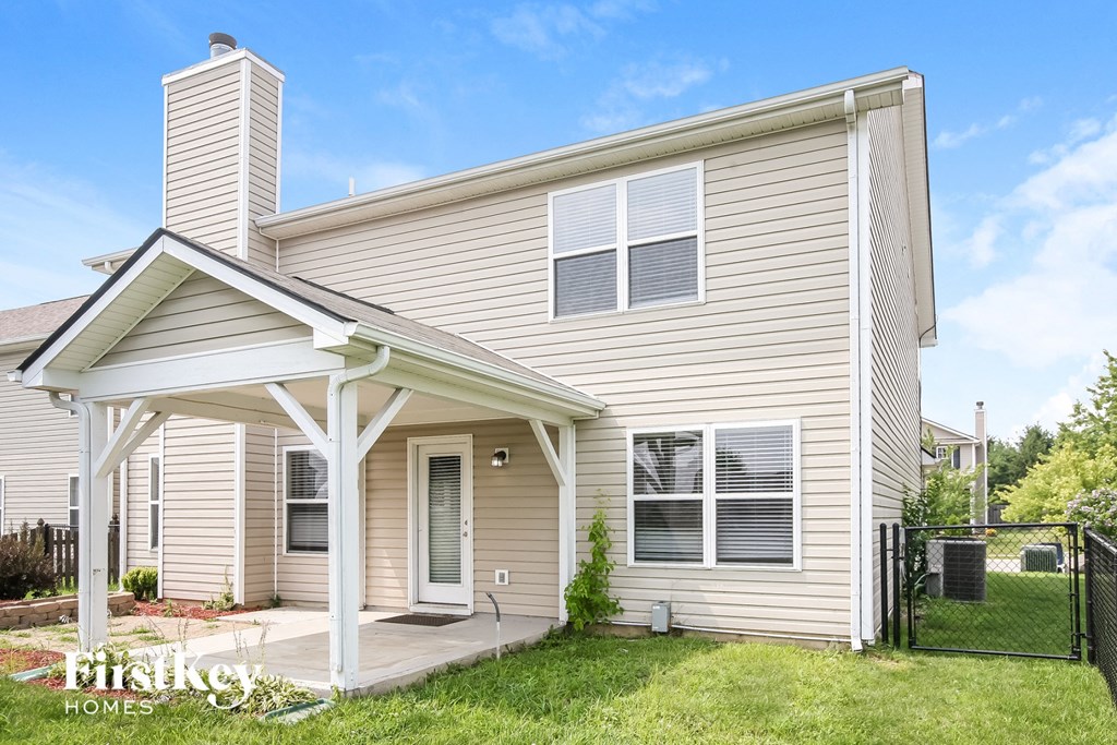 the outside of a house with a porch and a lawn