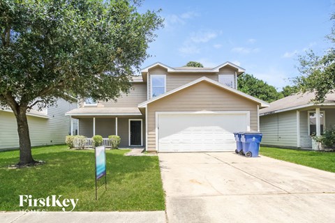a house with a driveway and a white garage door