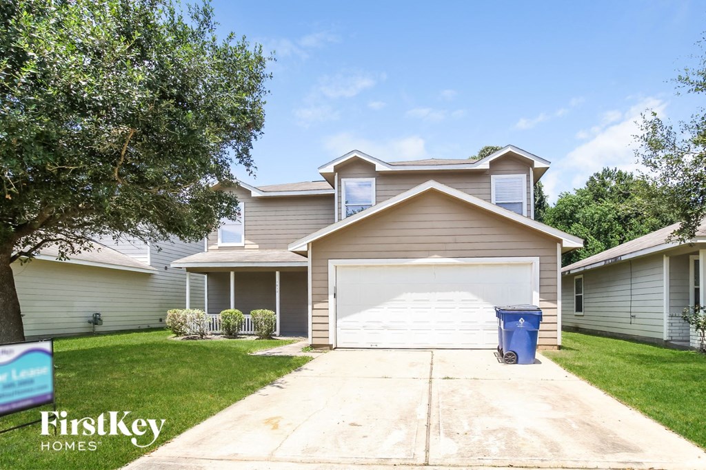 a house with a white garage door and a driveway
