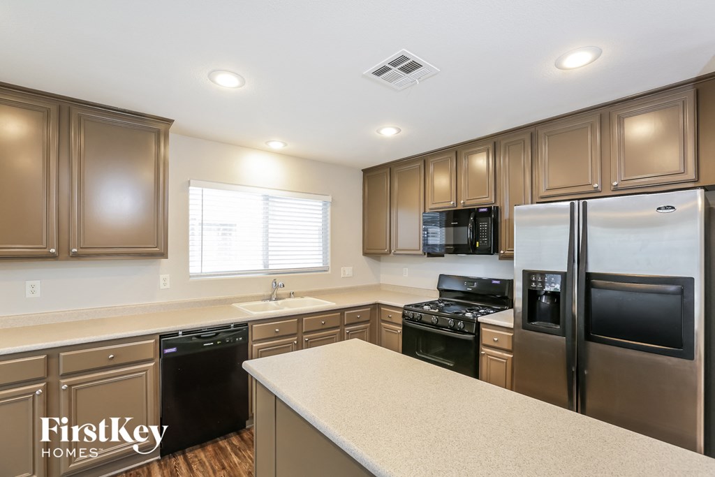 a kitchen with stainless steel appliances and white counter tops