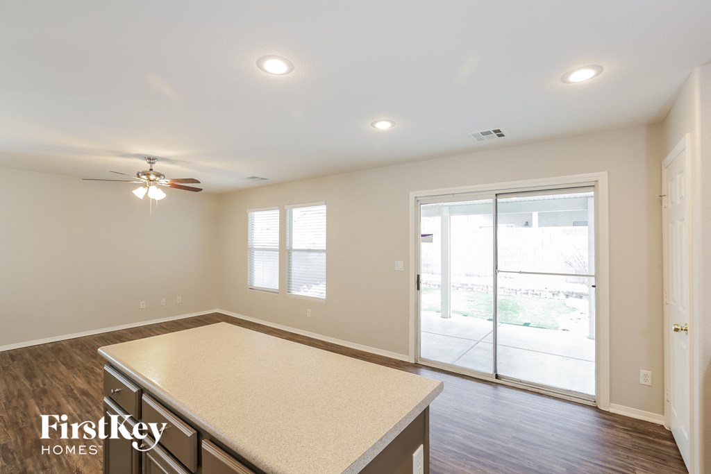 a kitchen with an island and a door to a patio
