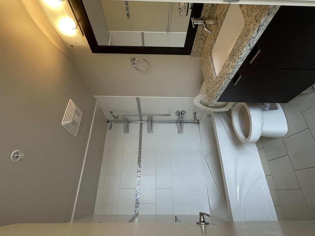 A bathroom with a shower and a toilet.