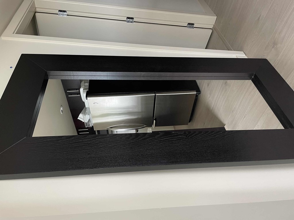 A stainless steel dishwasher is installed under a countertop.