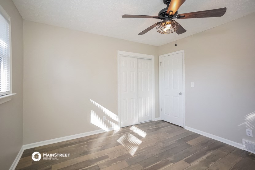 the living room of our studio apartment atrium with a ceiling fan