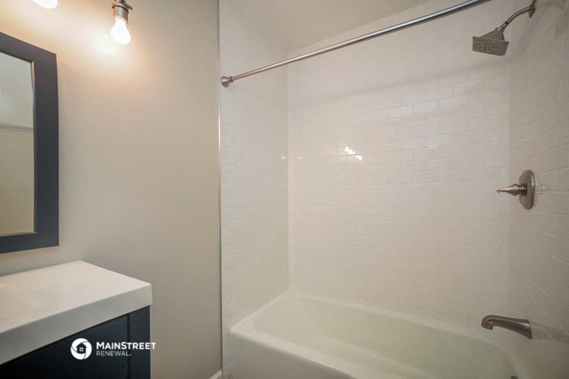 a bathroom with a shower and a sink and a bath tub
