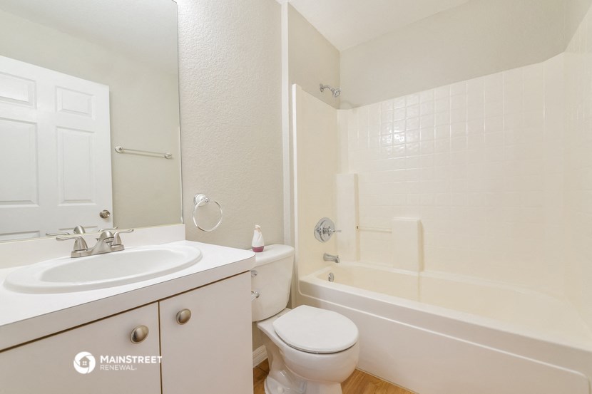 a bathroom with a sink toilet and a tub