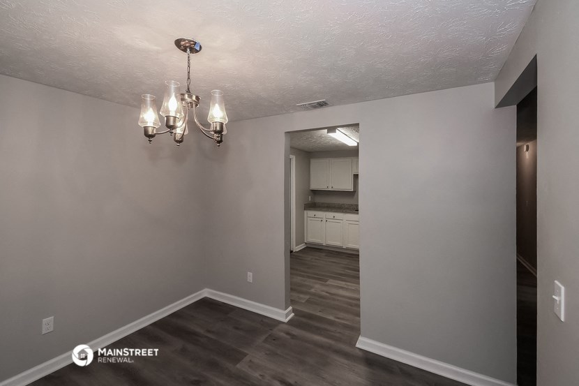 the living room and kitchen of a renovated modular home