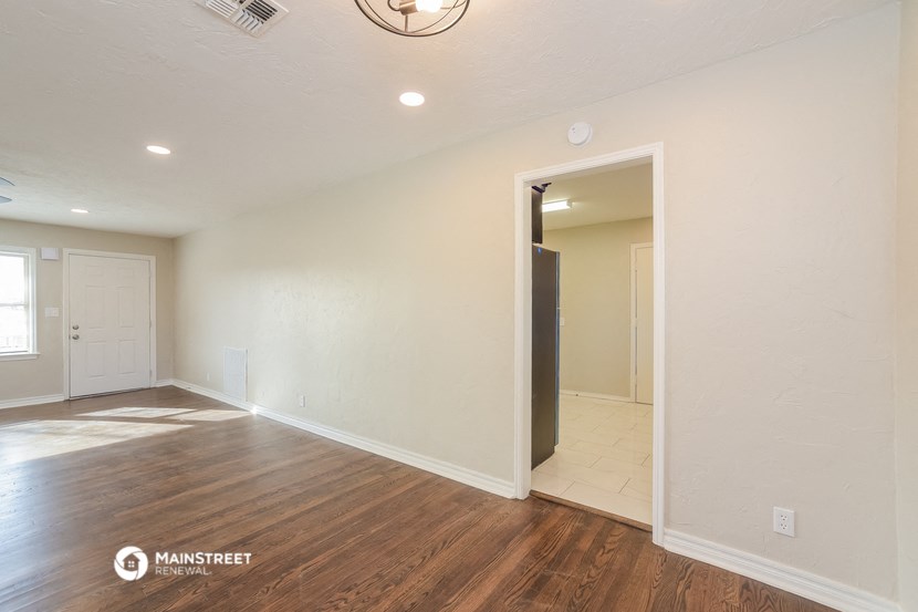 the living room and dining room of an empty renovated house