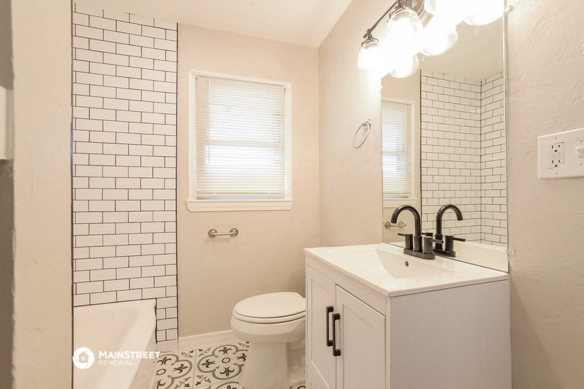 a bathroom with a sink and a toilet and a mirror