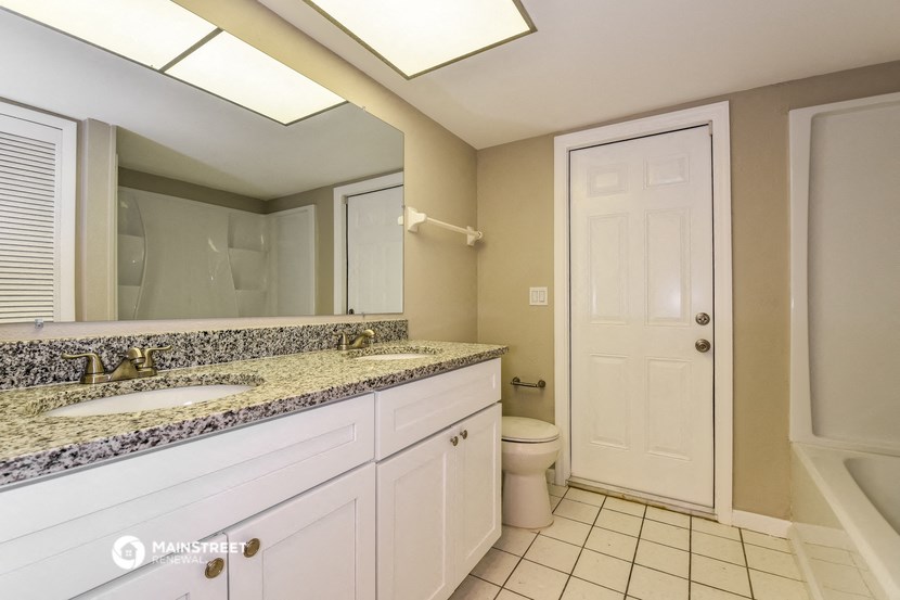 a bathroom with a sink and a toilet and a mirror