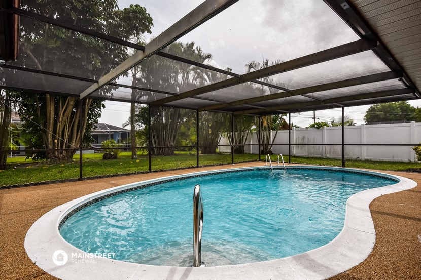 a swimming pool under a canopy in a backyard