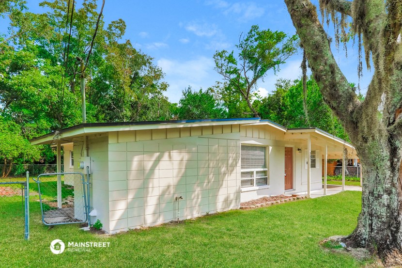 a small house with a tree in front of it