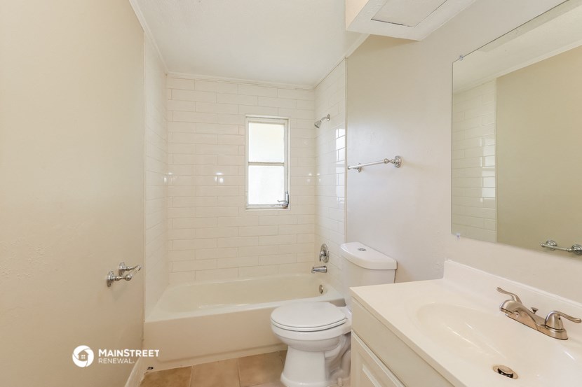 a bathroom with a sink toilet and a bath tub