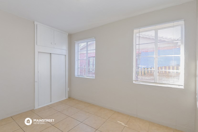 a room with a tiled floor and a door and window