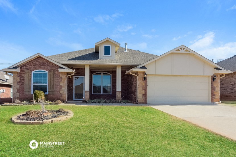a house with a lawn and a garage door