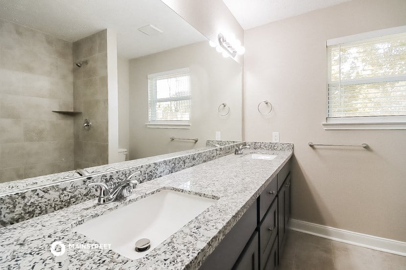 a bathroom with a sink and a mirror and a shower