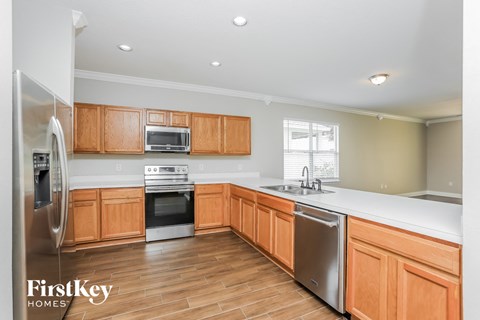 A kitchen with wooden cabinets and stainless steel appliances.
