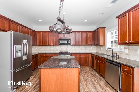 a kitchen with wooden cabinets and stainless steel appliances