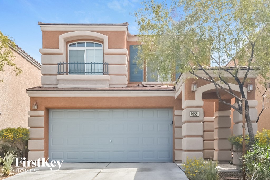 a house with a garage door in front of it