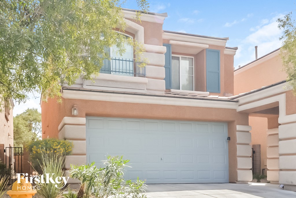 a house with a garage door in front of it