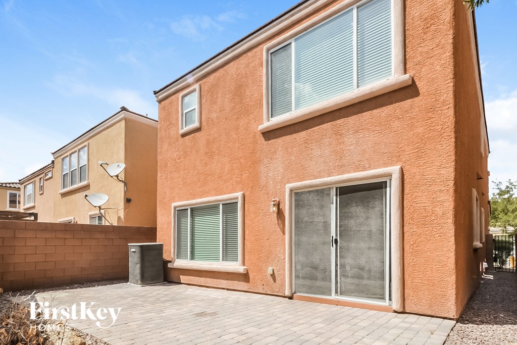 a brick house with a driveway and a glass door