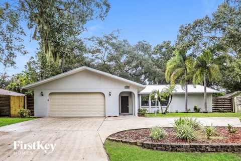 a white house with a driveway and a garage door