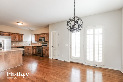 A modern kitchen with wooden cabinets and a large island.