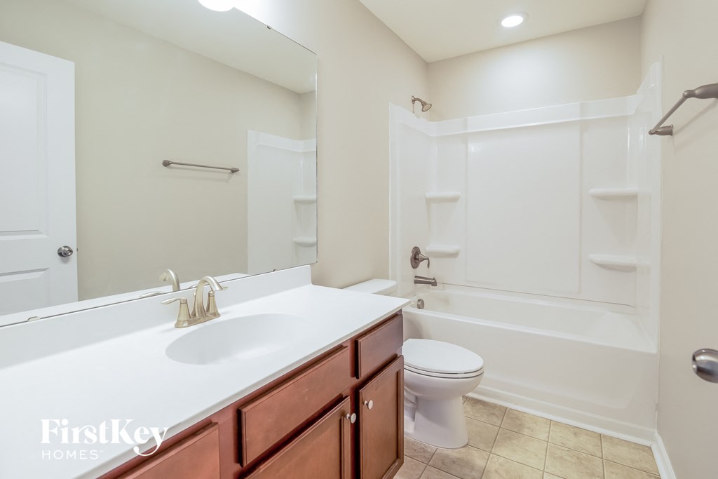 a bathroom with a sink and a toilet and a shower