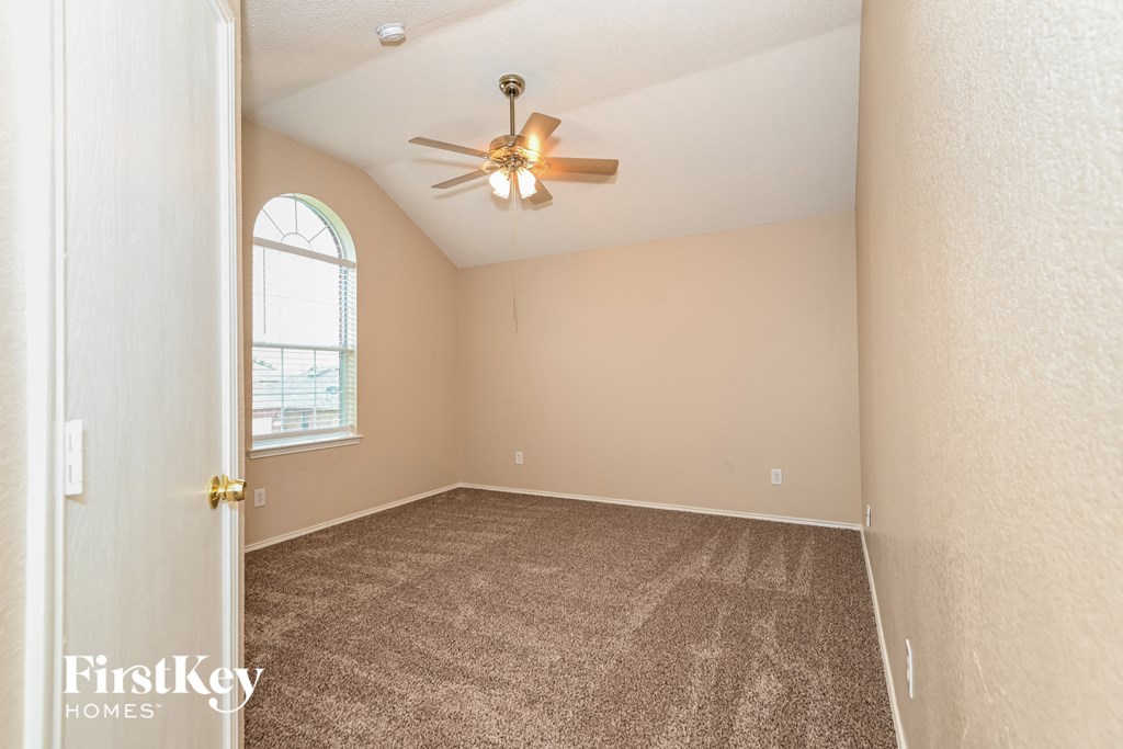 a bedroom with carpet and a ceiling fan