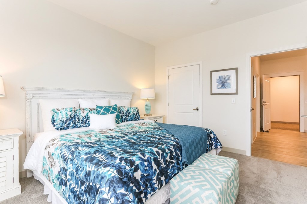 a bedroom with a bed and a door to a bathroom