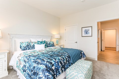 a bedroom with a bed and a door to a bathroom
