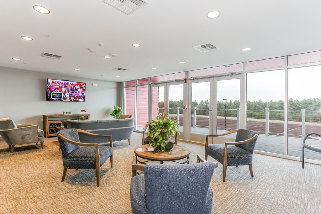 a large room with chairs and a table and a television