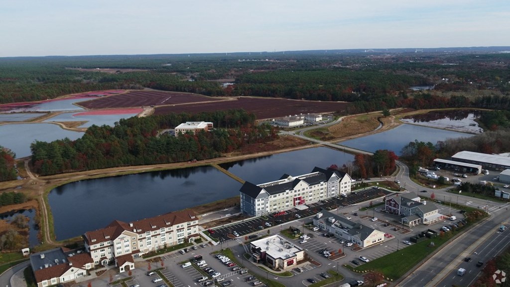 an aerial view of a city with a lake and buildings