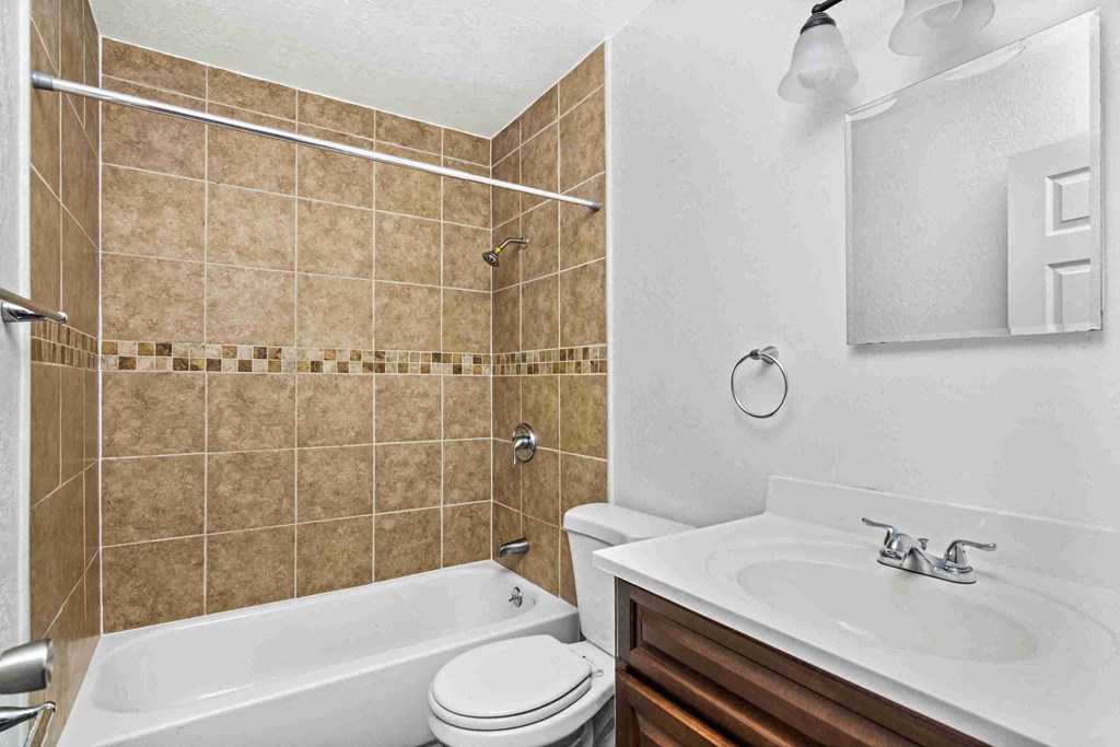 a bathroom with a sink toilet and a bath tub