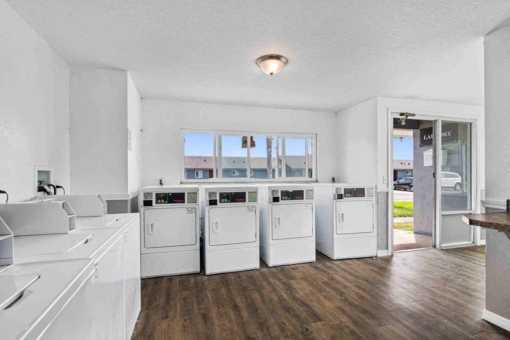 a laundry room with washes and dryers in it