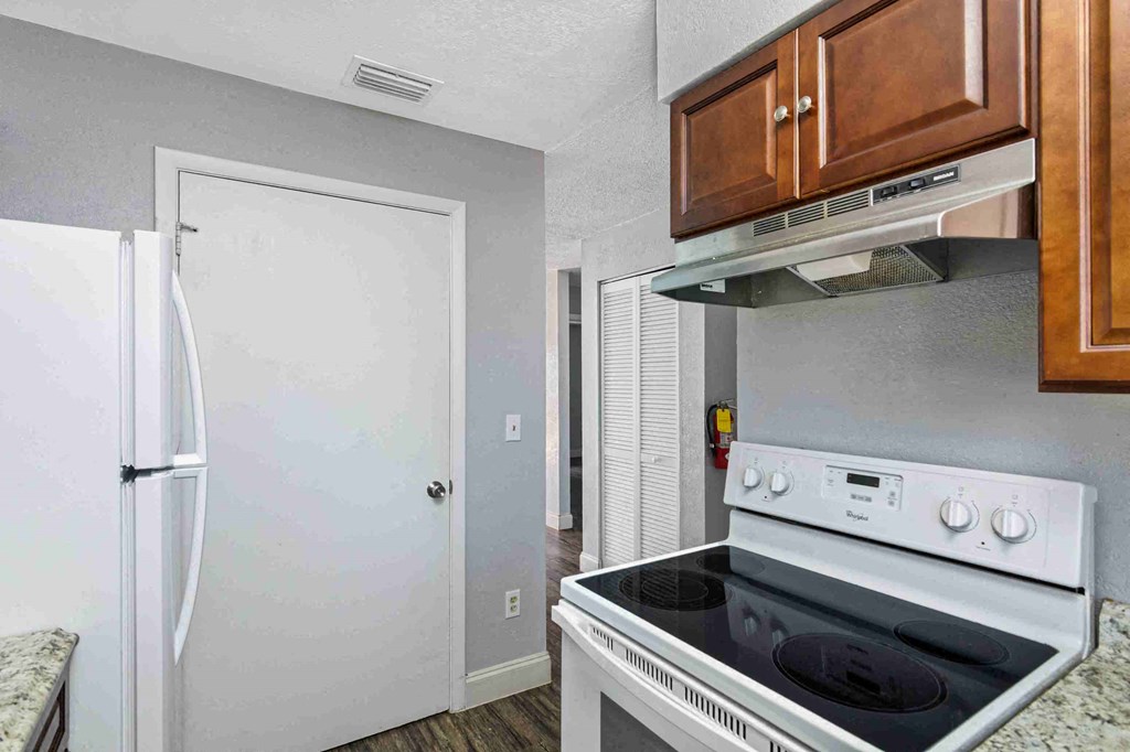 a kitchen with a stove and a refrigerator