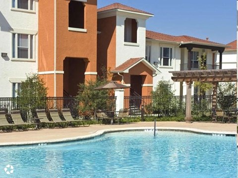 a swimming pool in front of an apartment building