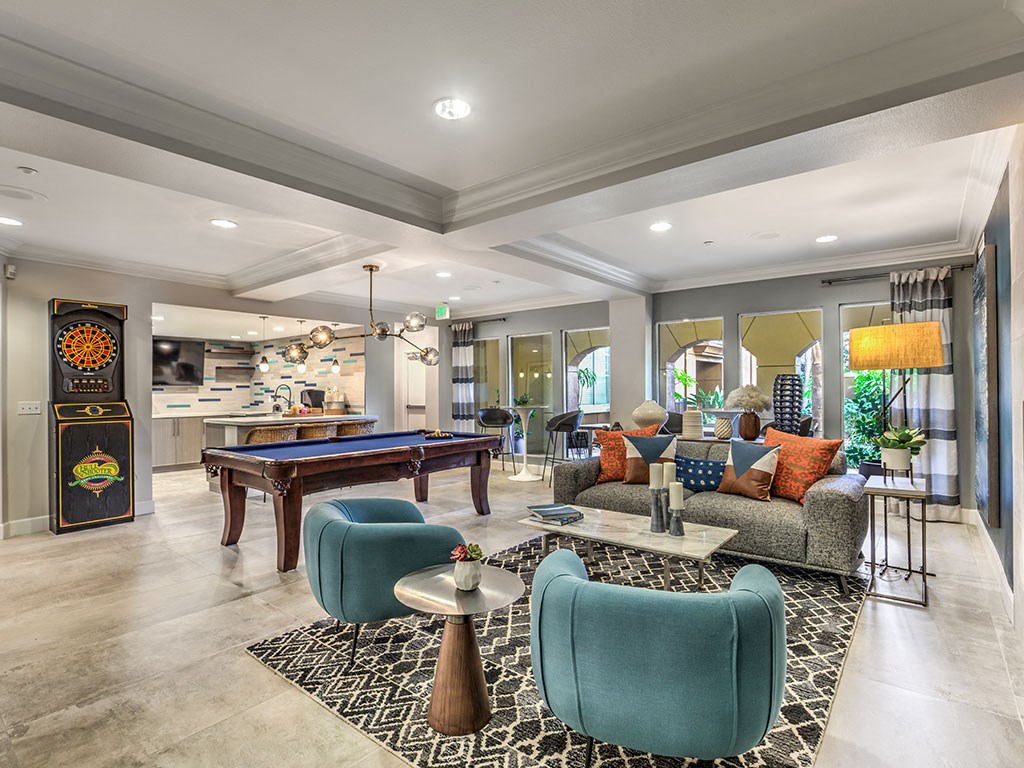 a clubhouse with a pool table and a living room