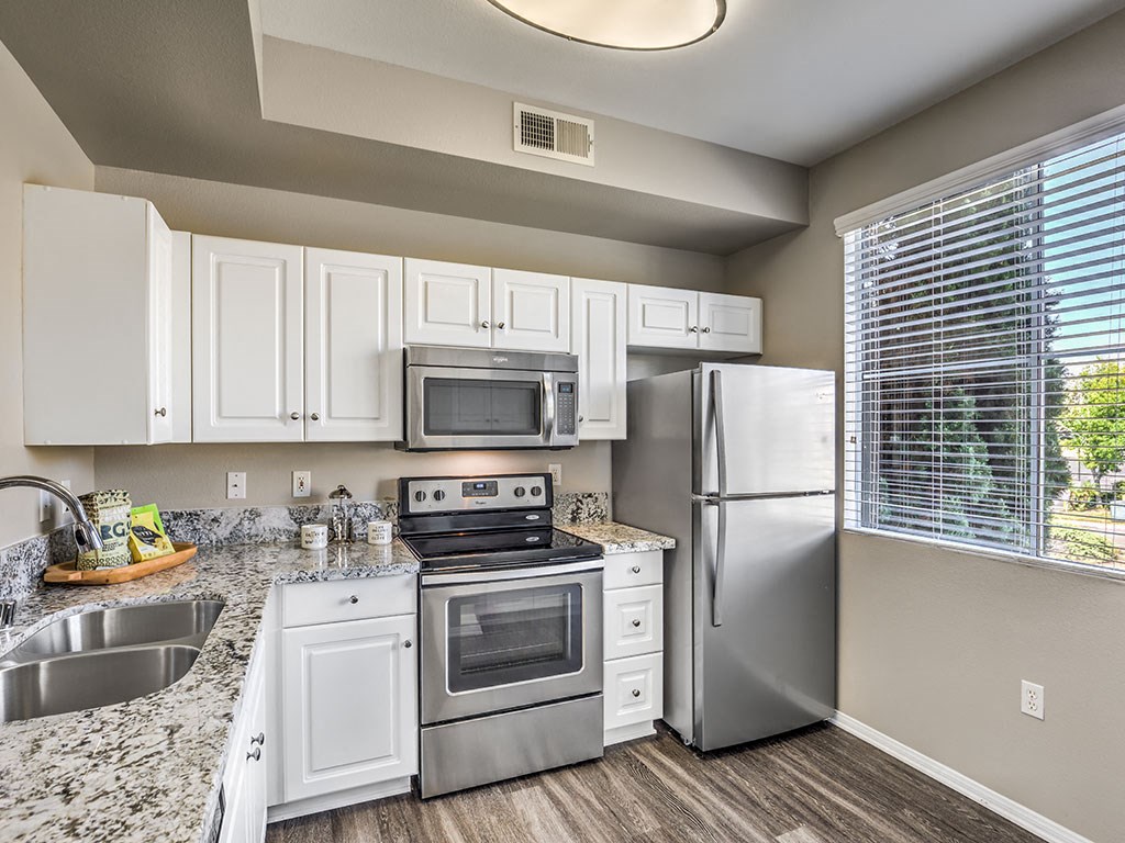 a kitchen with stainless steel appliances and white cabinets